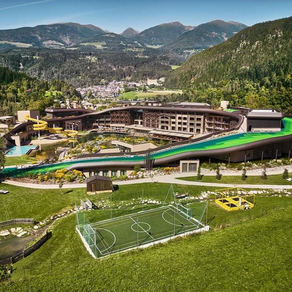 Aerial view of Falkensteiner Family Resort Lido with mountain backdrop
