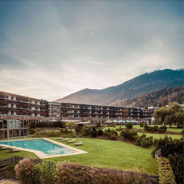 Exterior view of Falkensteiner Hotel Sonnenalpe with outdoor pool and landscaped garden
