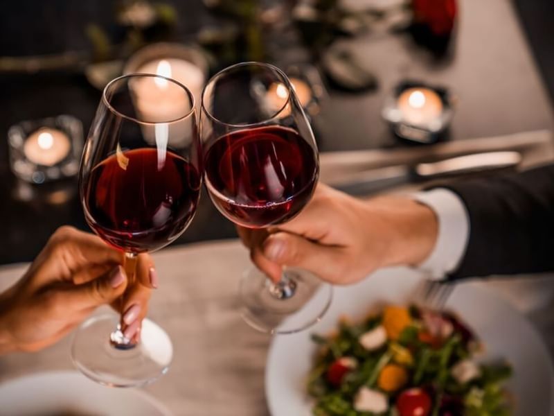 Two people clinking wine glasses in Wine Cellar Chateau Hacienda Galindo Resort & Spa at Fiesta Americana