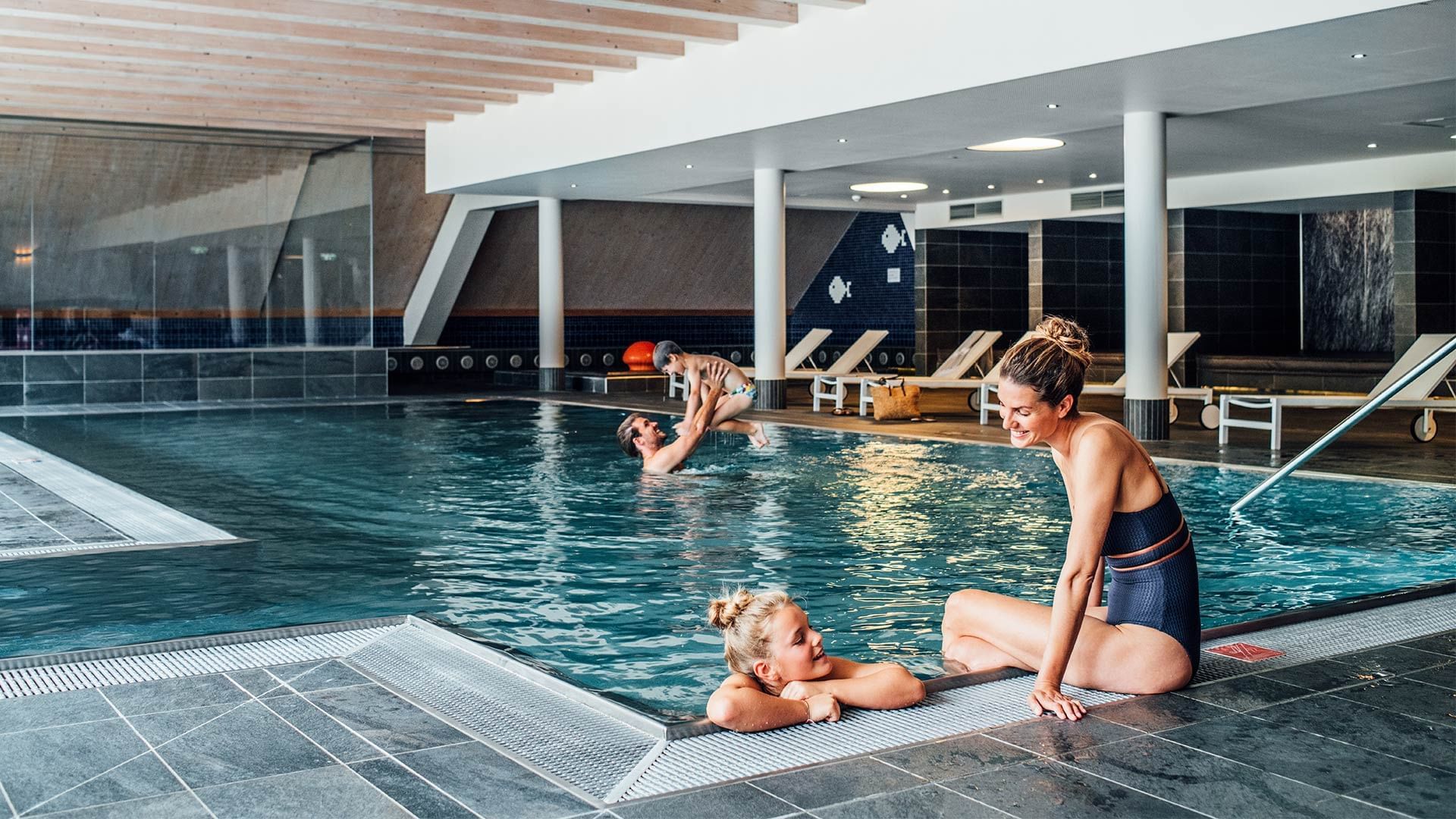 Family enjoying the indoor pool at Falkensteiner Hotel Sonnenalpe