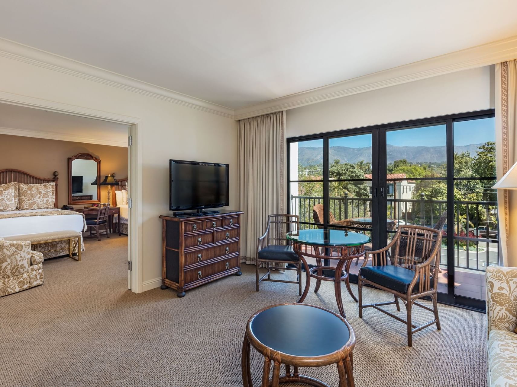 Separated living and bedroom area in Standard Two Queen with a balcony at Santa Barbara Inn Hotel