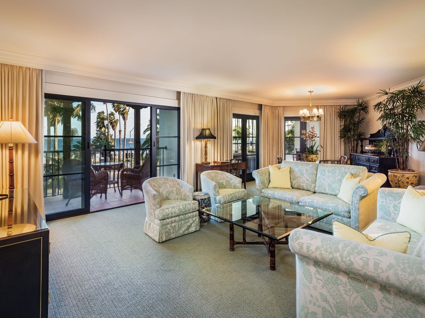 Lavish Anacapa Suite One King at Santa Barbara Inn with soft furniture, a glass table, and scenic views from the balcony