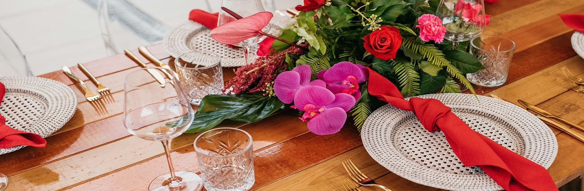 Close-up of table with napkins, floral centerpiece & gold cutlery at Pullman Port Douglas Sea Temple Resort & Spa