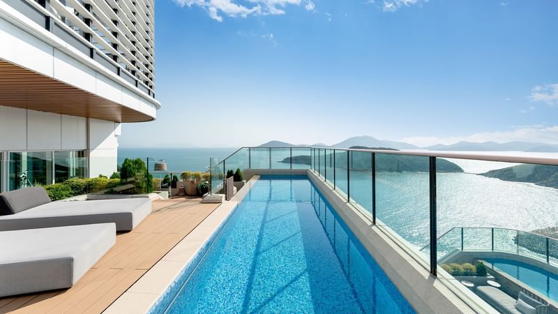 Outdoor pool area with sea view in The Penthouse Pool Suite at Fullerton Ocean Park Hotel Hong Kong