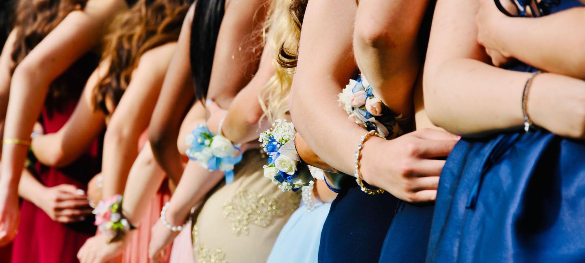 A group of girls in elegant wedding dresses posing together at The Fullerton Hotel Sydney