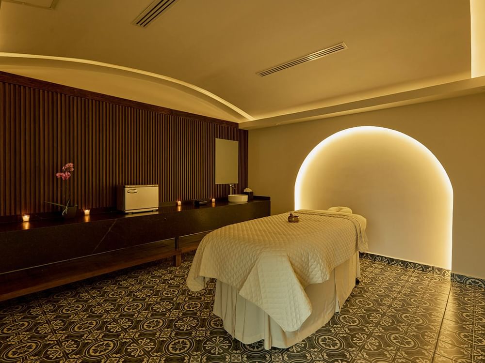 Spa room with massage table, soft lighting, wooden accents at Fiesta Americana Hacienda San Antonio el Puente Resort & Spa