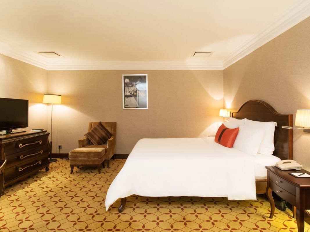 Deluxe Family Room with a twin bed & comfy chair at Eastin Grand Hotel Saigon